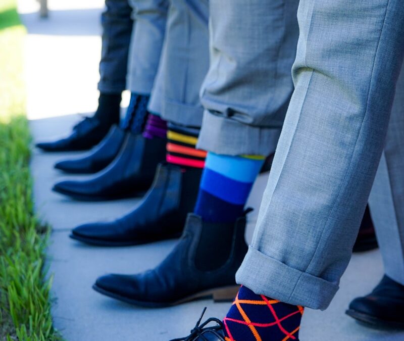 people showing black leather dress shoe lot outdoor during daytime