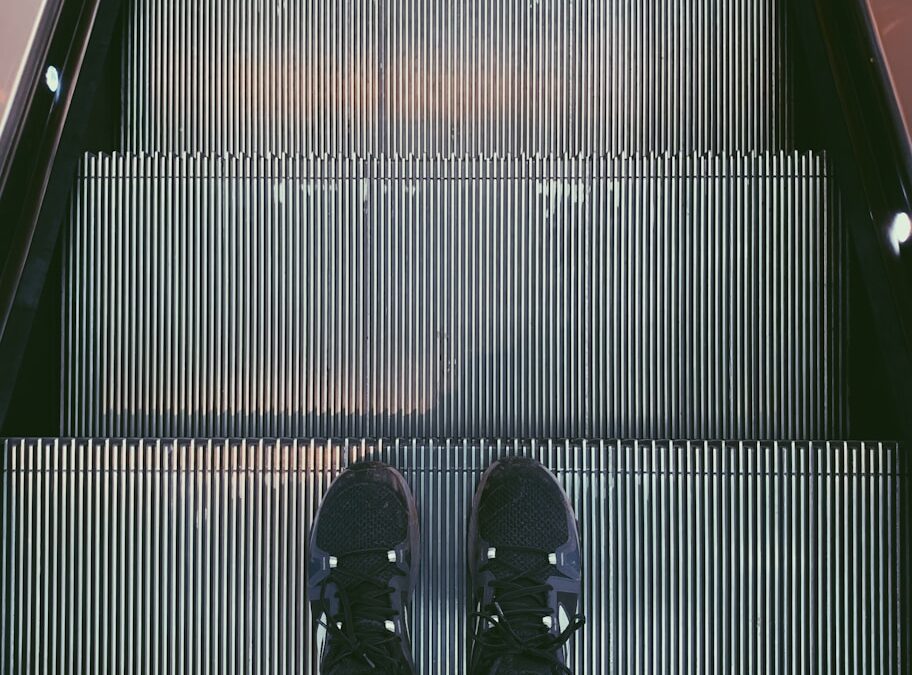 person standing on escalator