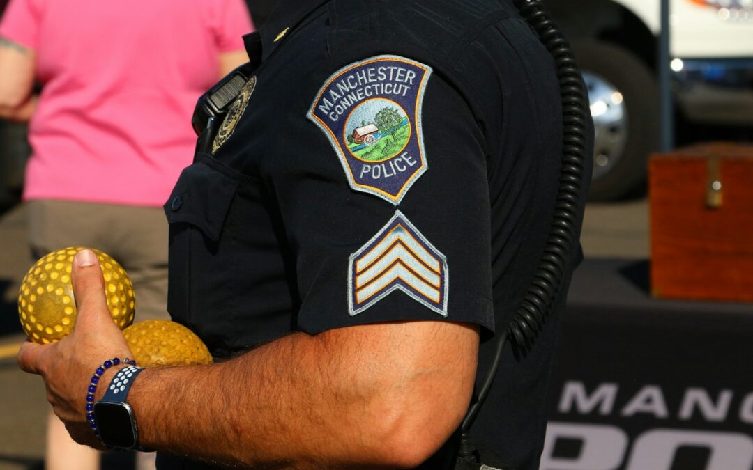 Police officer holding two golden balls
