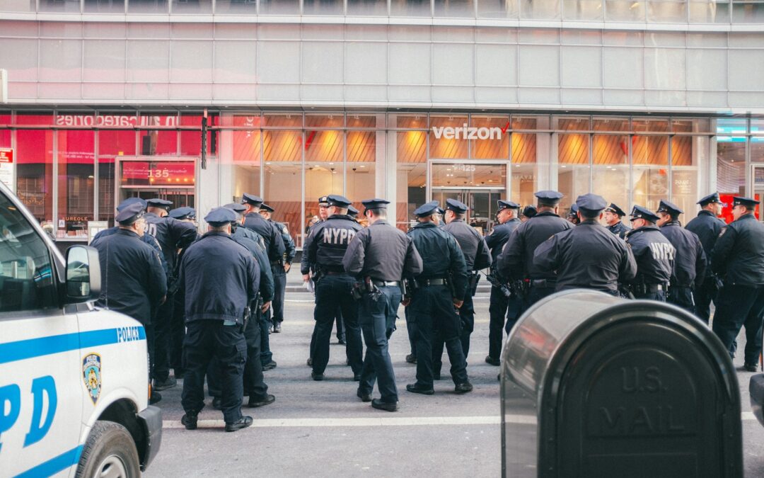 a group of police officers standing in front of a building